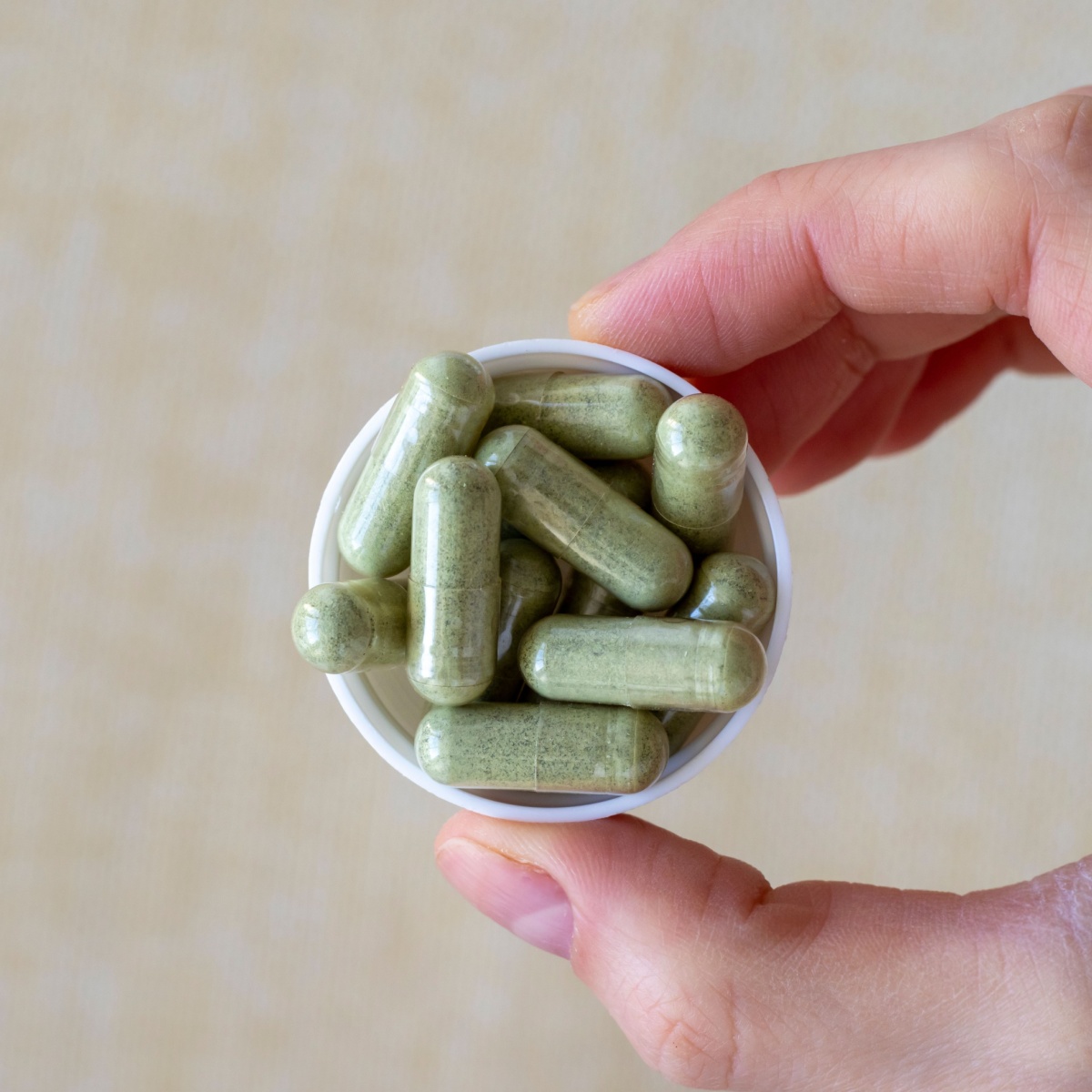 green supplements on a cap