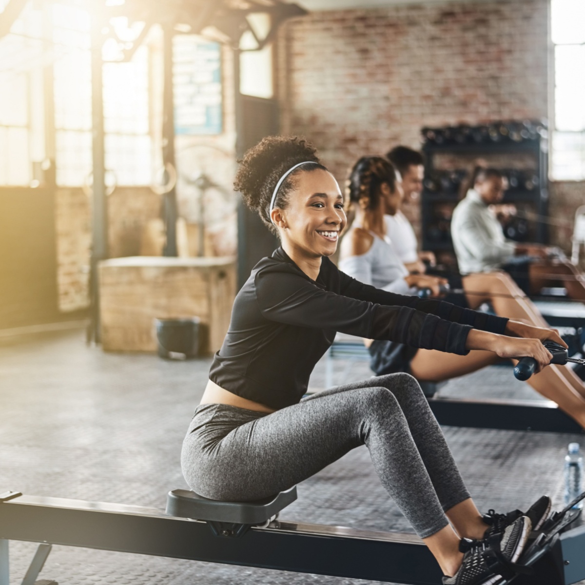 woman practicing indoor rowing