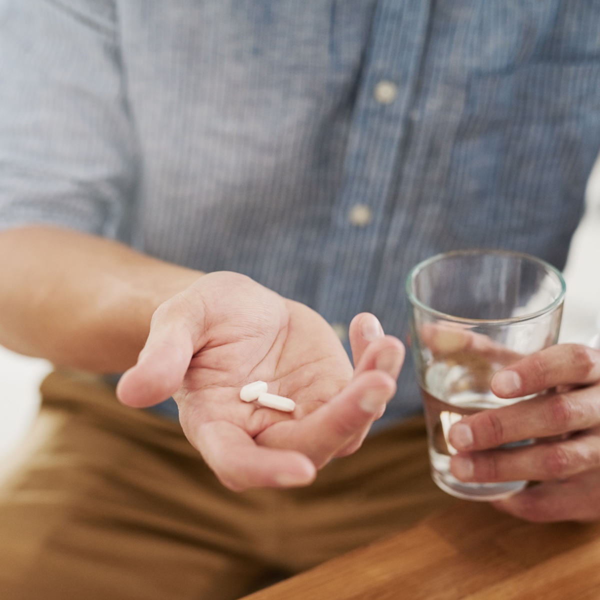 man holding pill in his hand