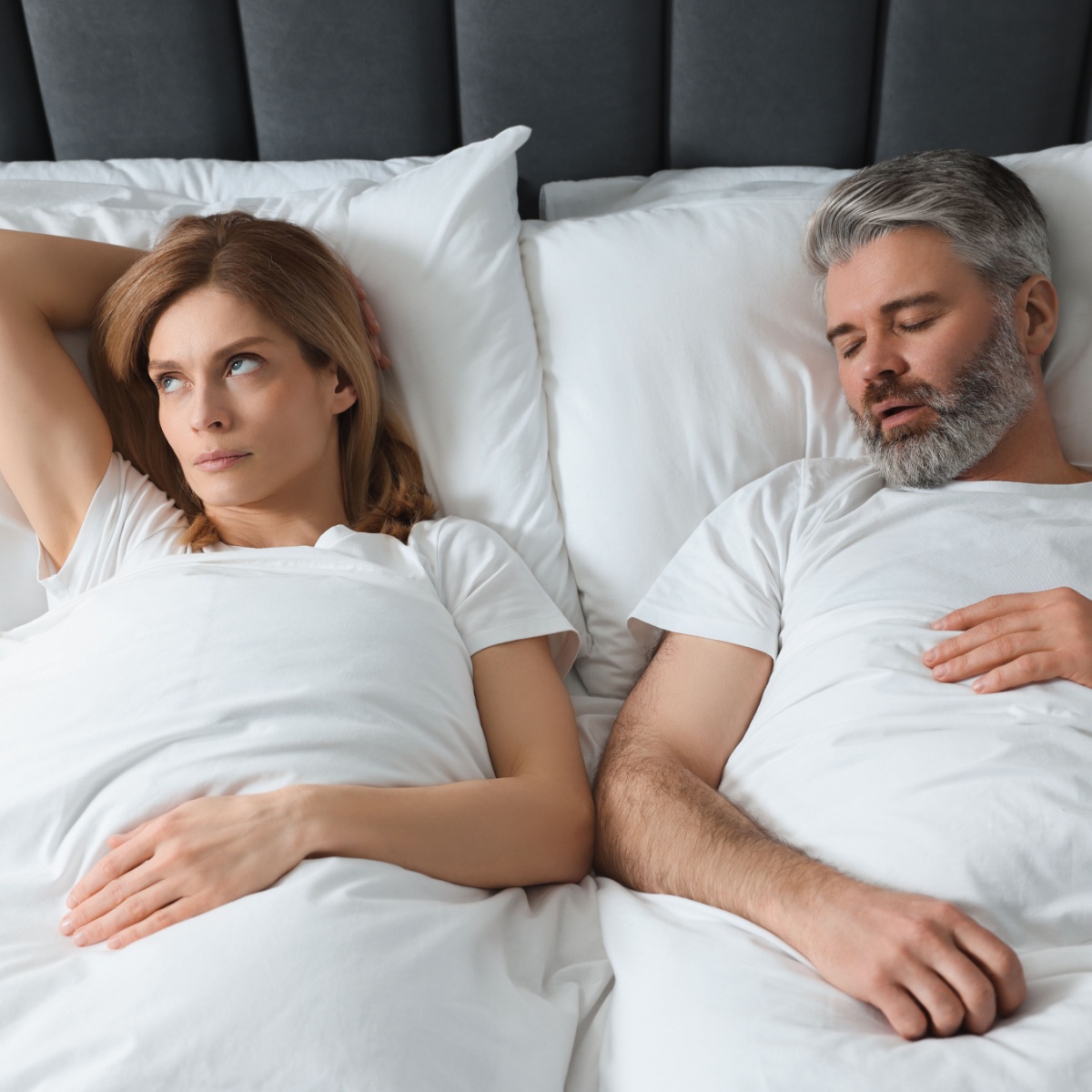 woman irritated by snoring husband