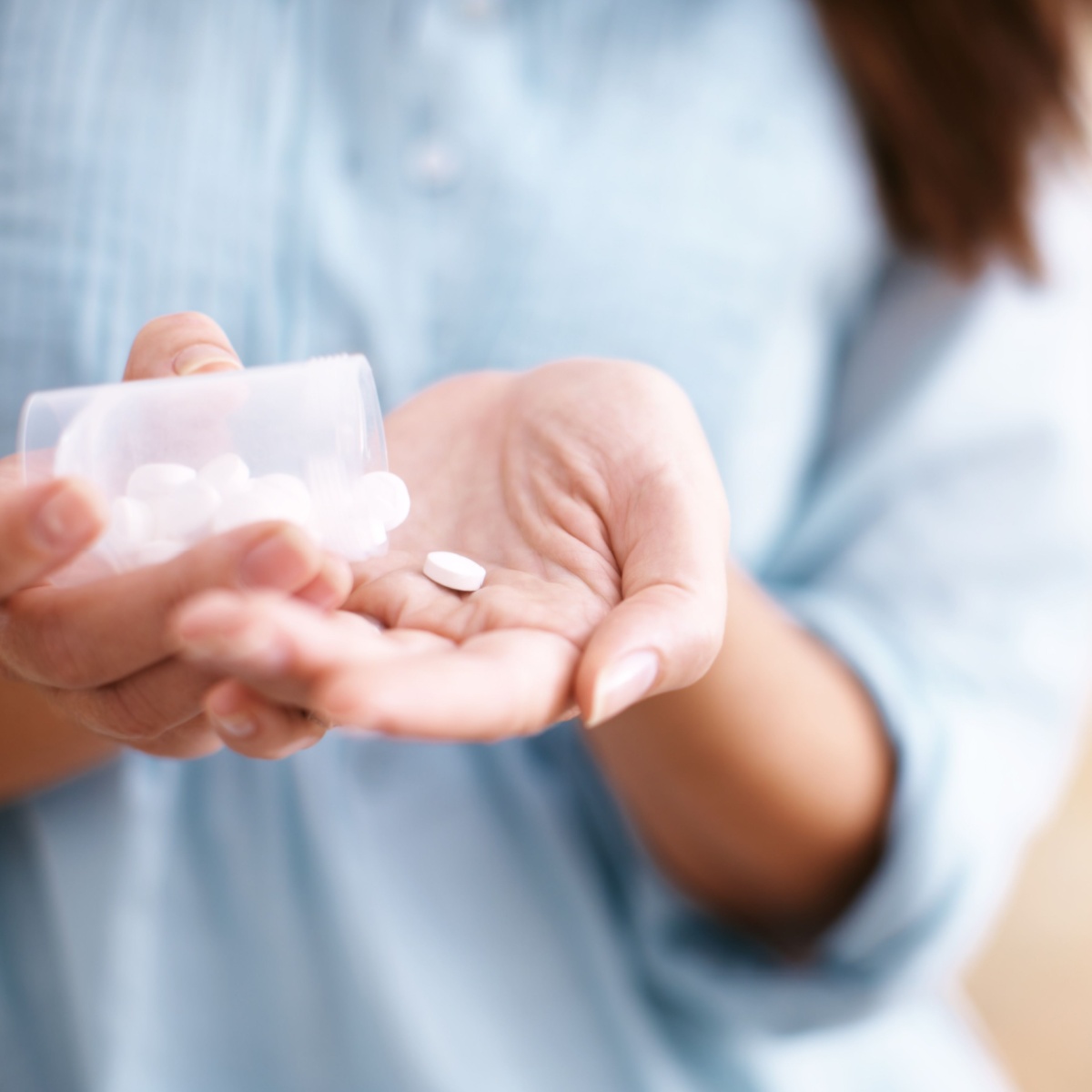 woman holding supplements