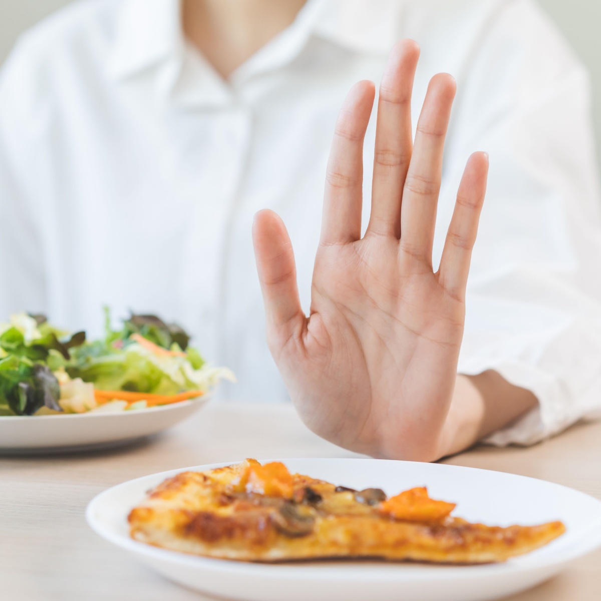 person refusing a slice of pizza