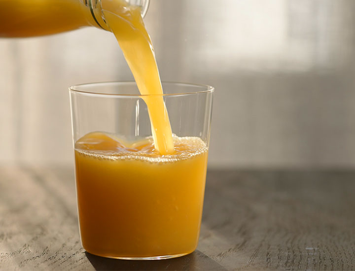 orange juice in glass cup