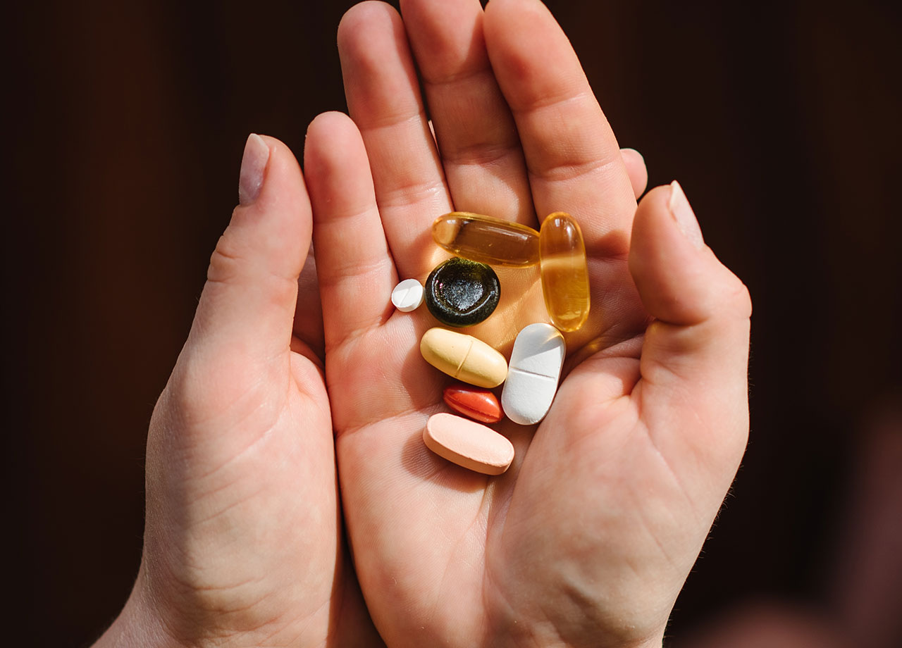 Woman holding vitamins