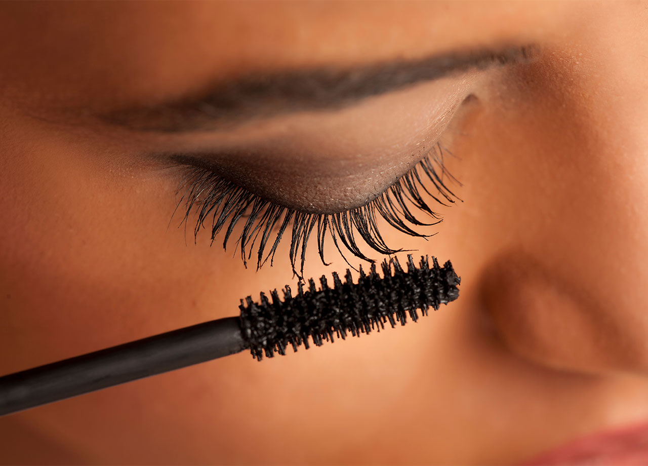 woman-looking-down-apply-mascara