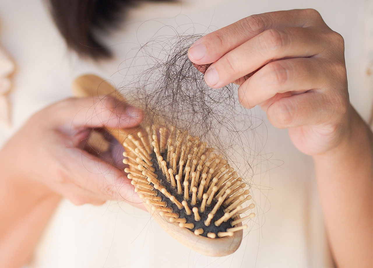 woman-pulling-hair-brush