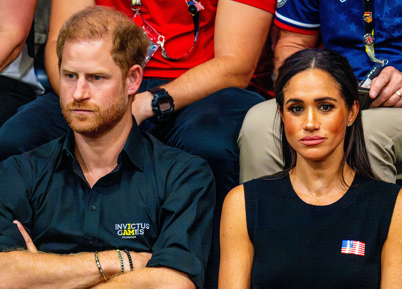 Prince Harry and Meghan Markle looking serious at the Invictus Games