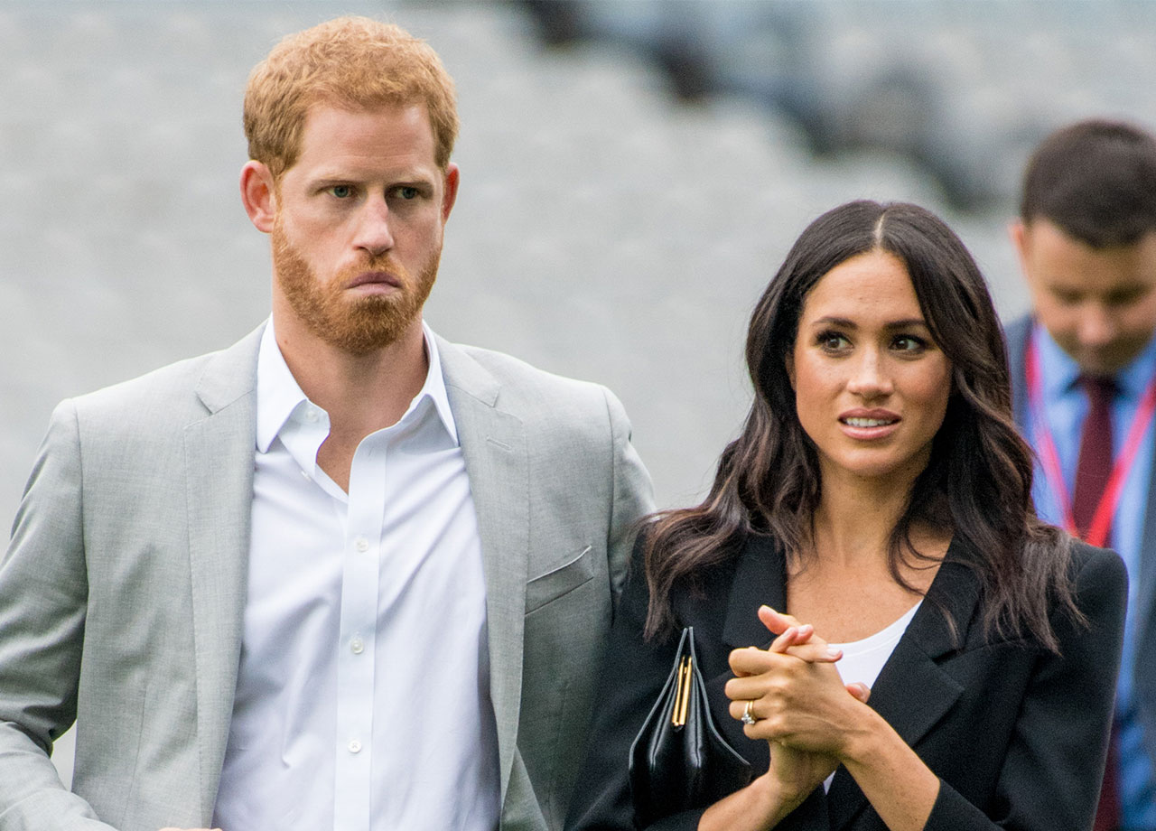 Prince Harry and Meghan Markle looking upset