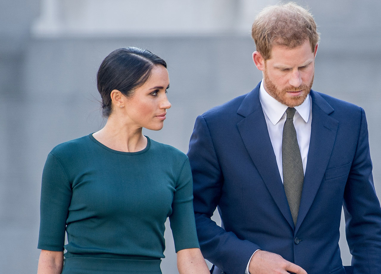 Prince Harry and Meghan Markle looking concerned