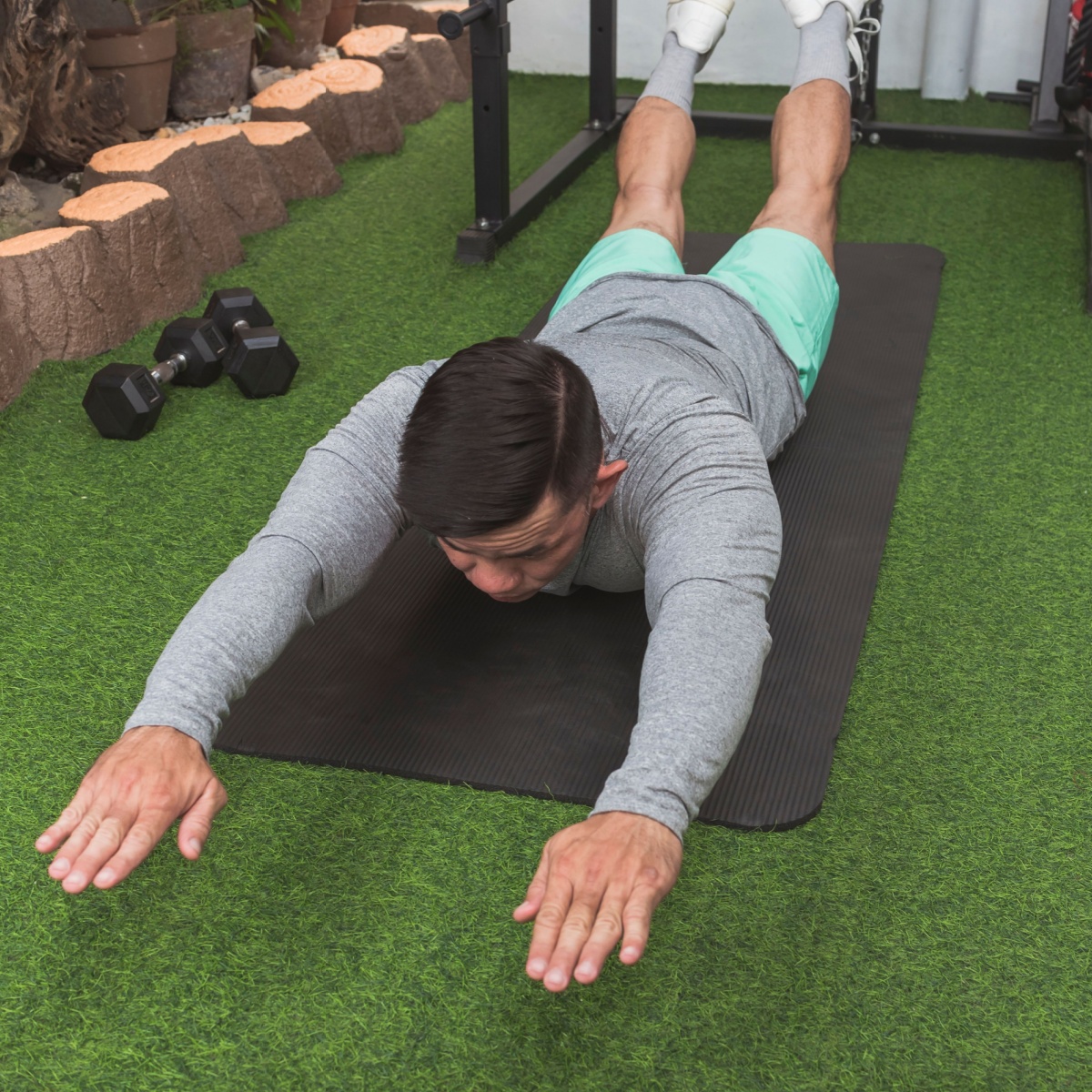 man exercising superman