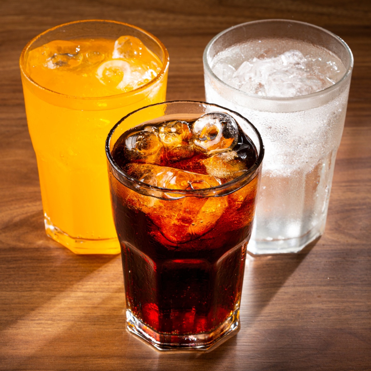 three glasses of carbonated drinks