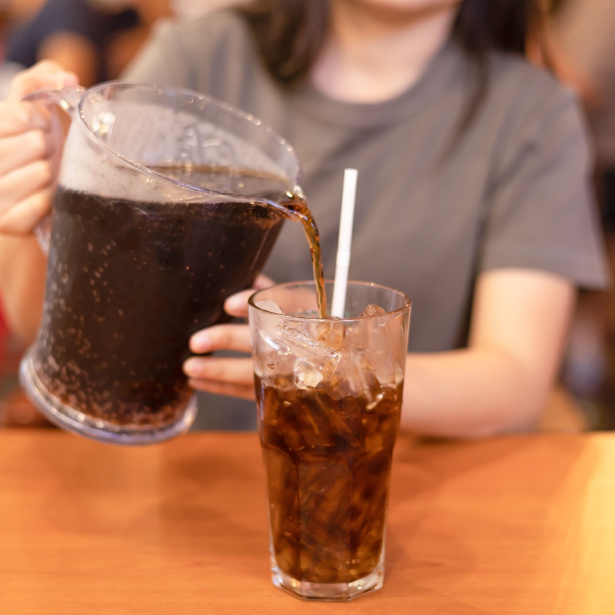 woman pouring soda