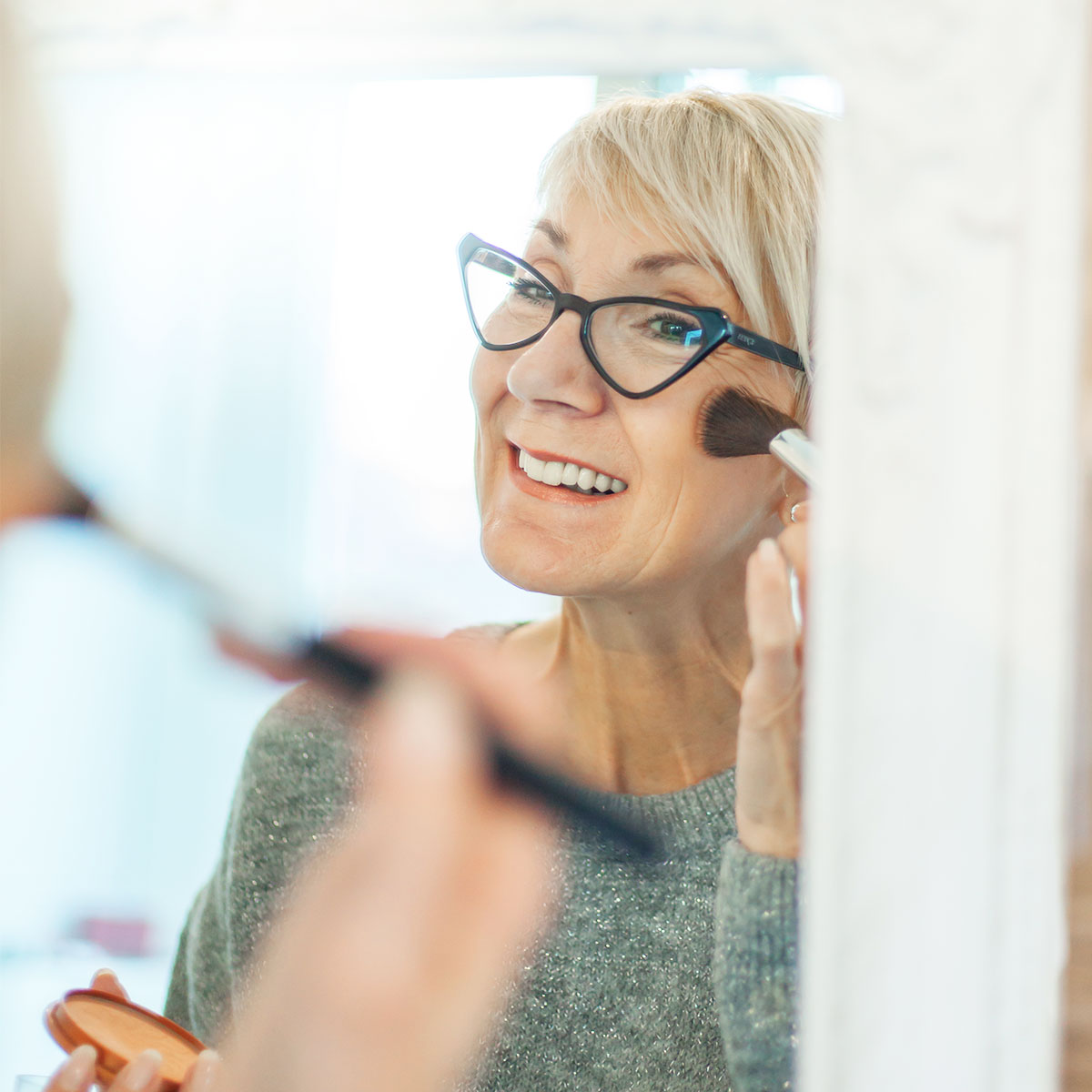 mature-woman-applying-makeup