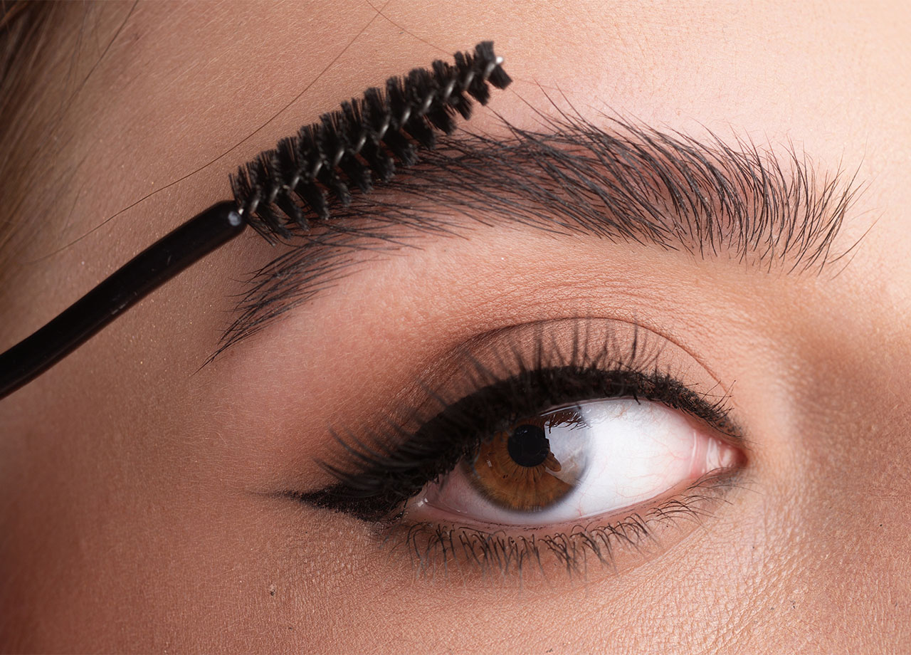 woman-brushing-eyebrows