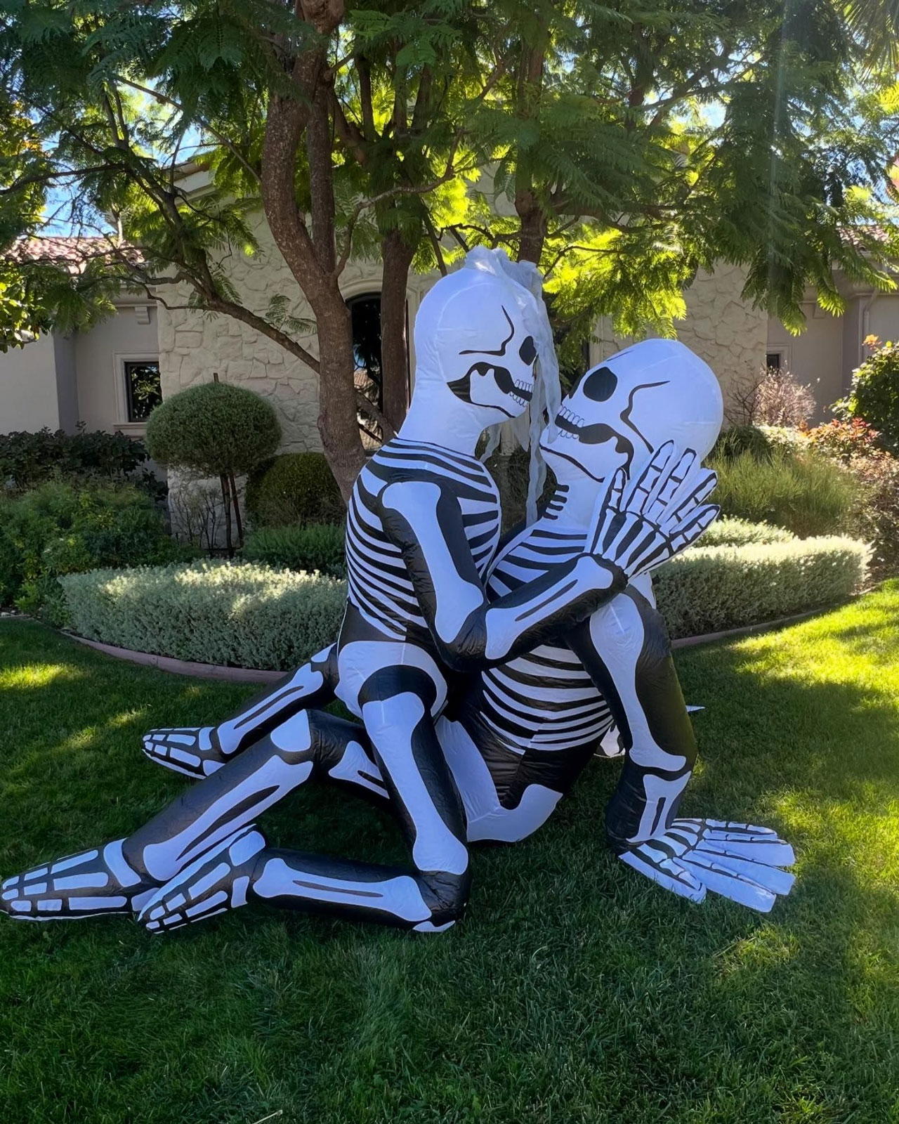 Kourtney Kardashian and Travis Barker inflatable skeletons Halloween decor