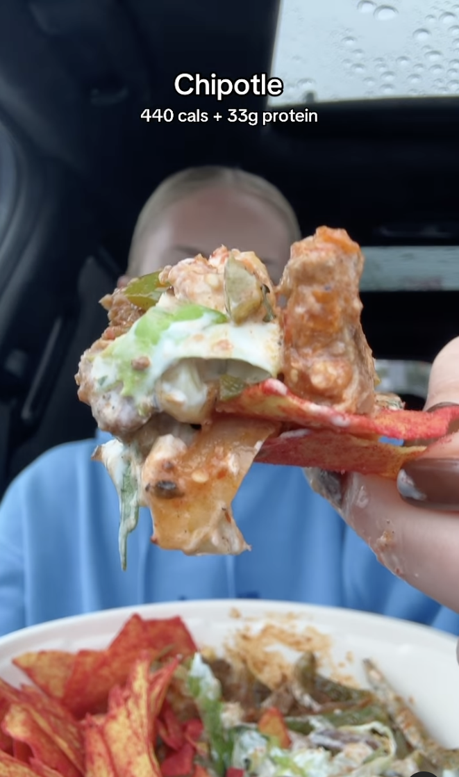 woman holding chipotle brisket order