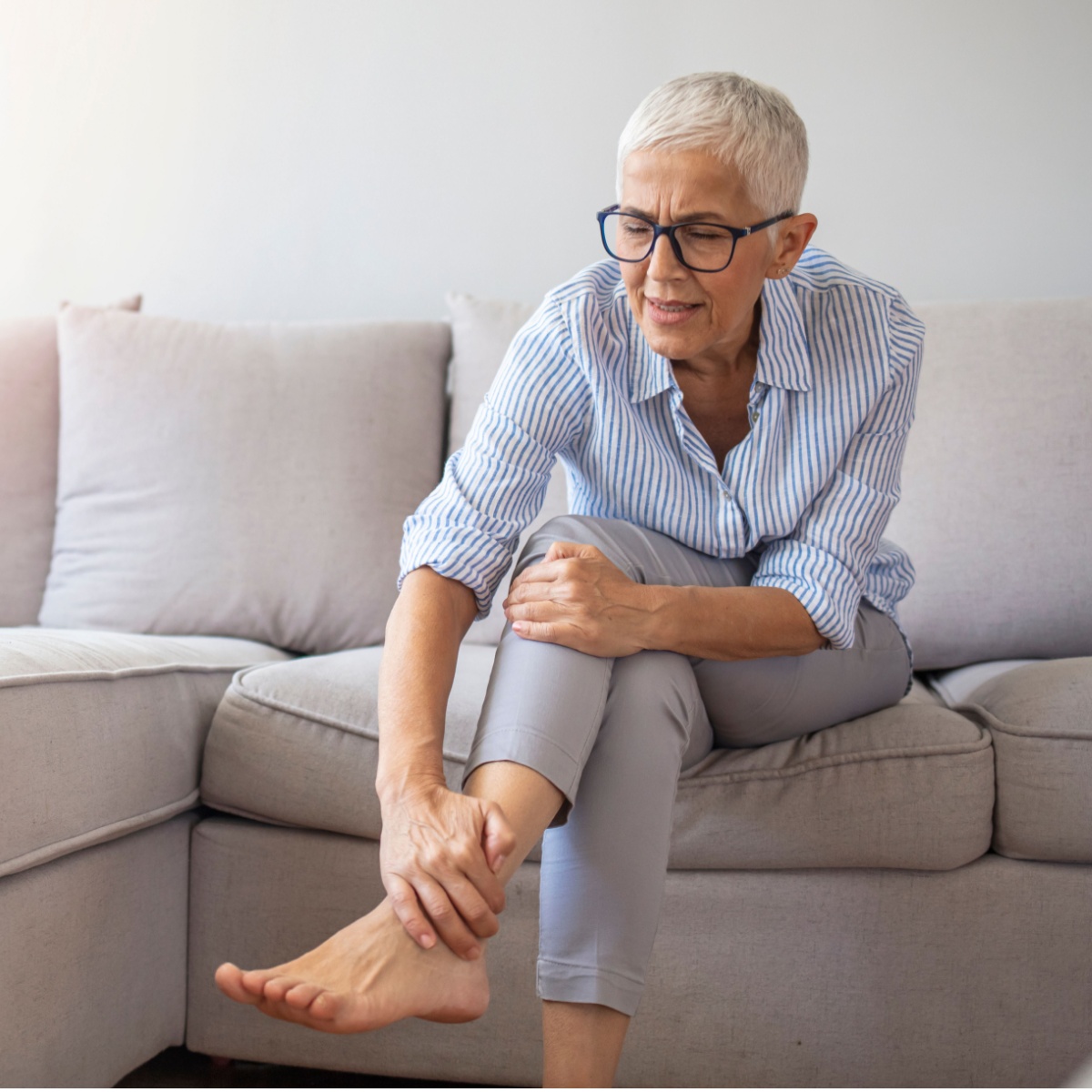 woman holding her ankle