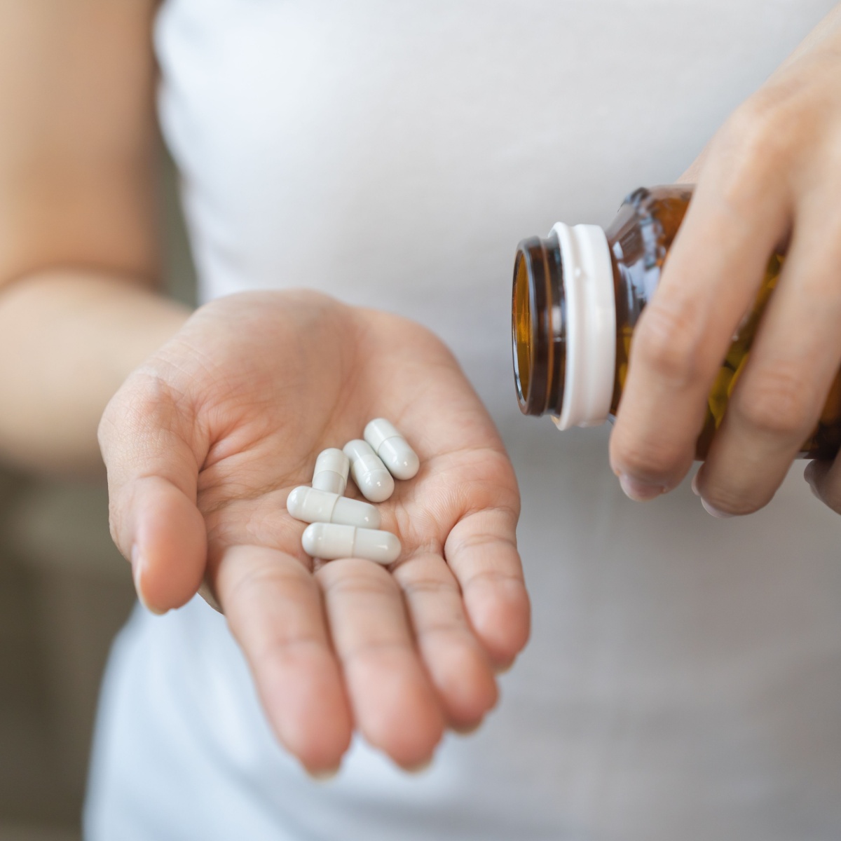 woman with supplements in her palm