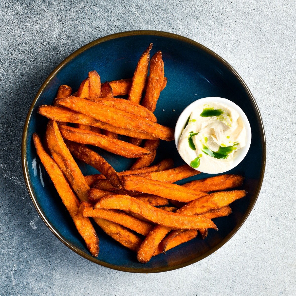 plate of sweet potato fries with sauce