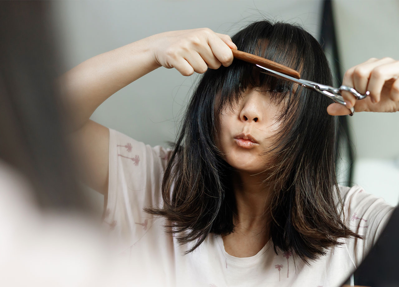 woman-cutting-bangs