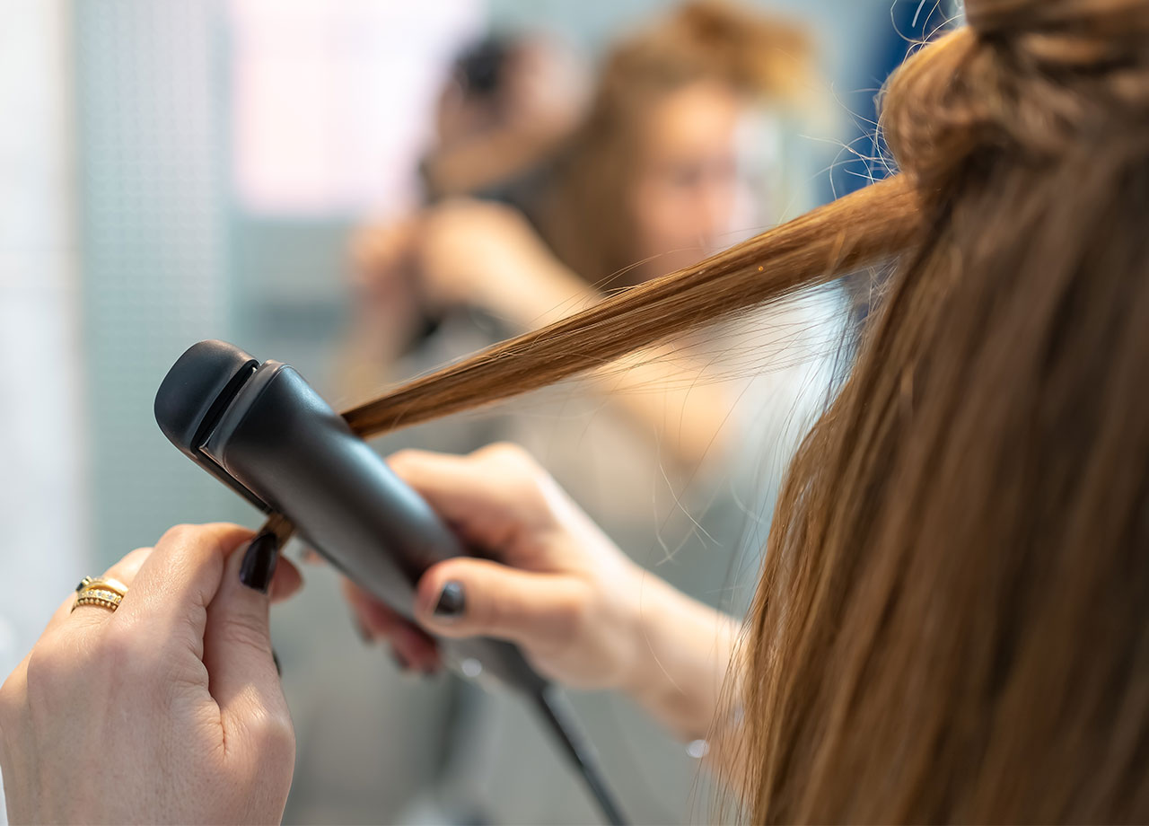 woman-straightening-hair