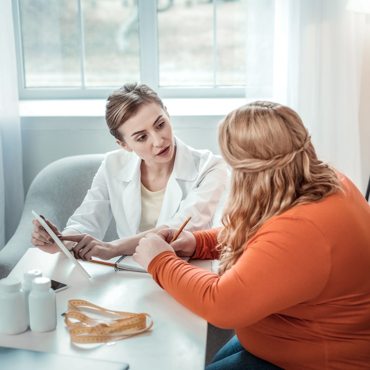 doctor and overweight woman speaking