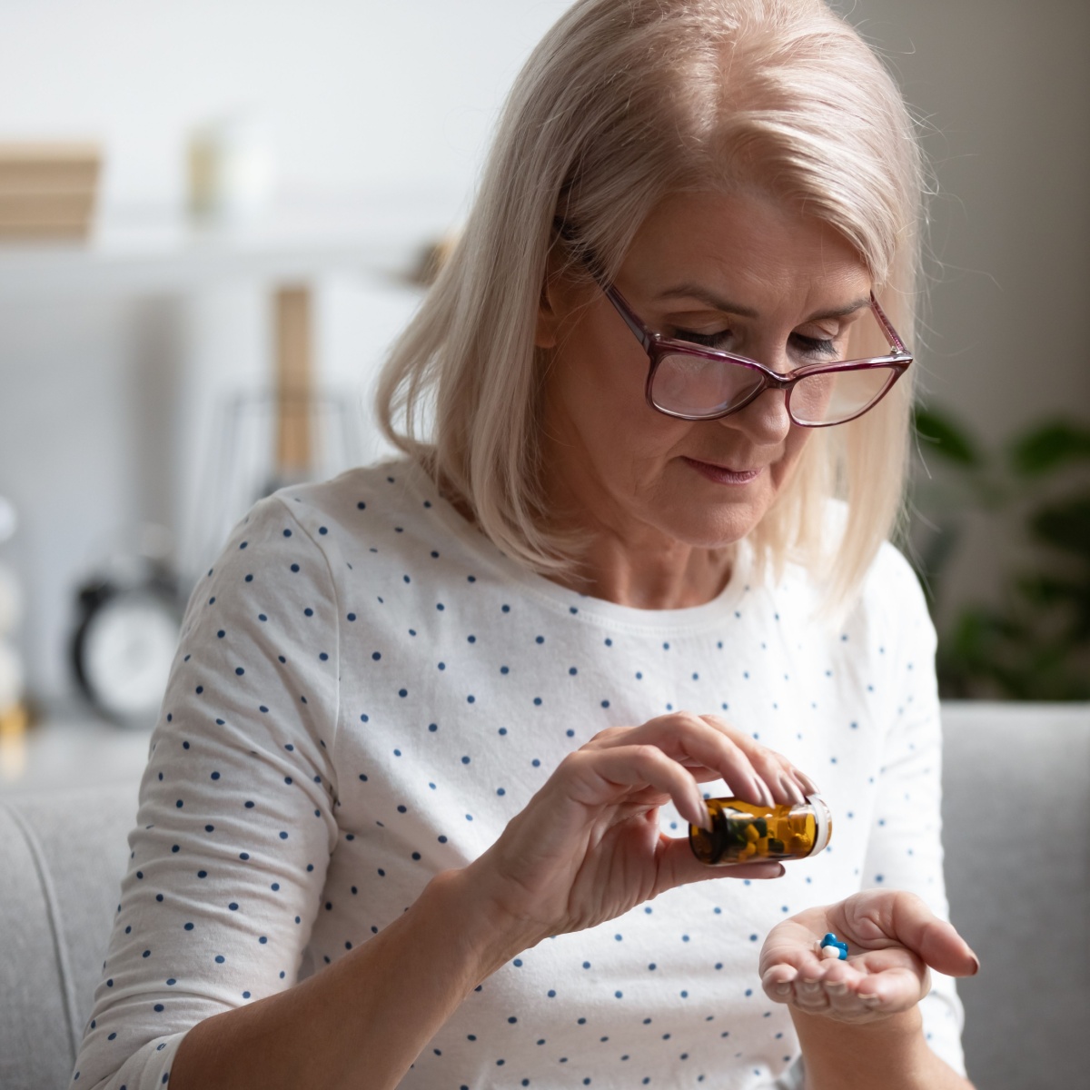 older woman looking at supplement