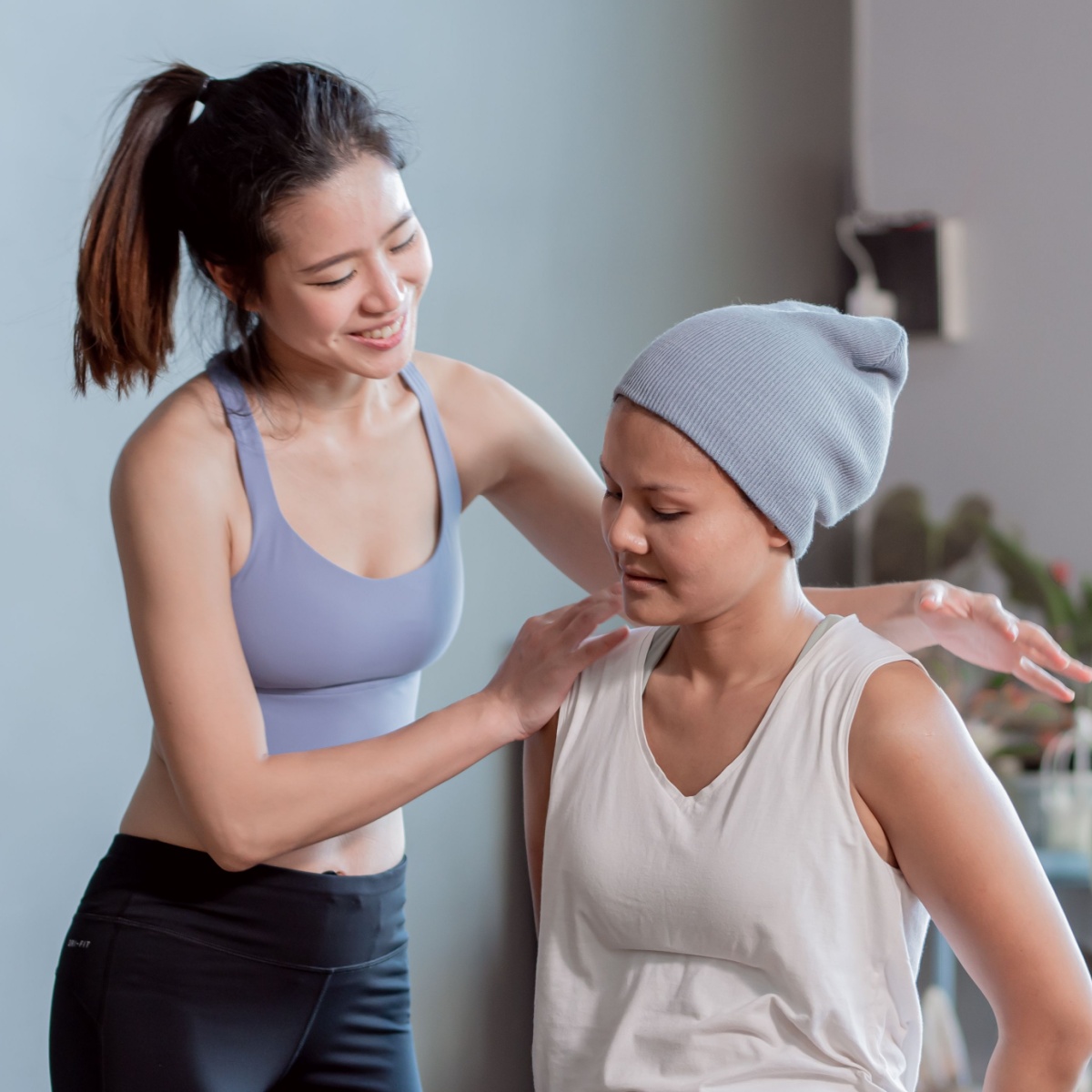 woman with cancer and an exercise coach