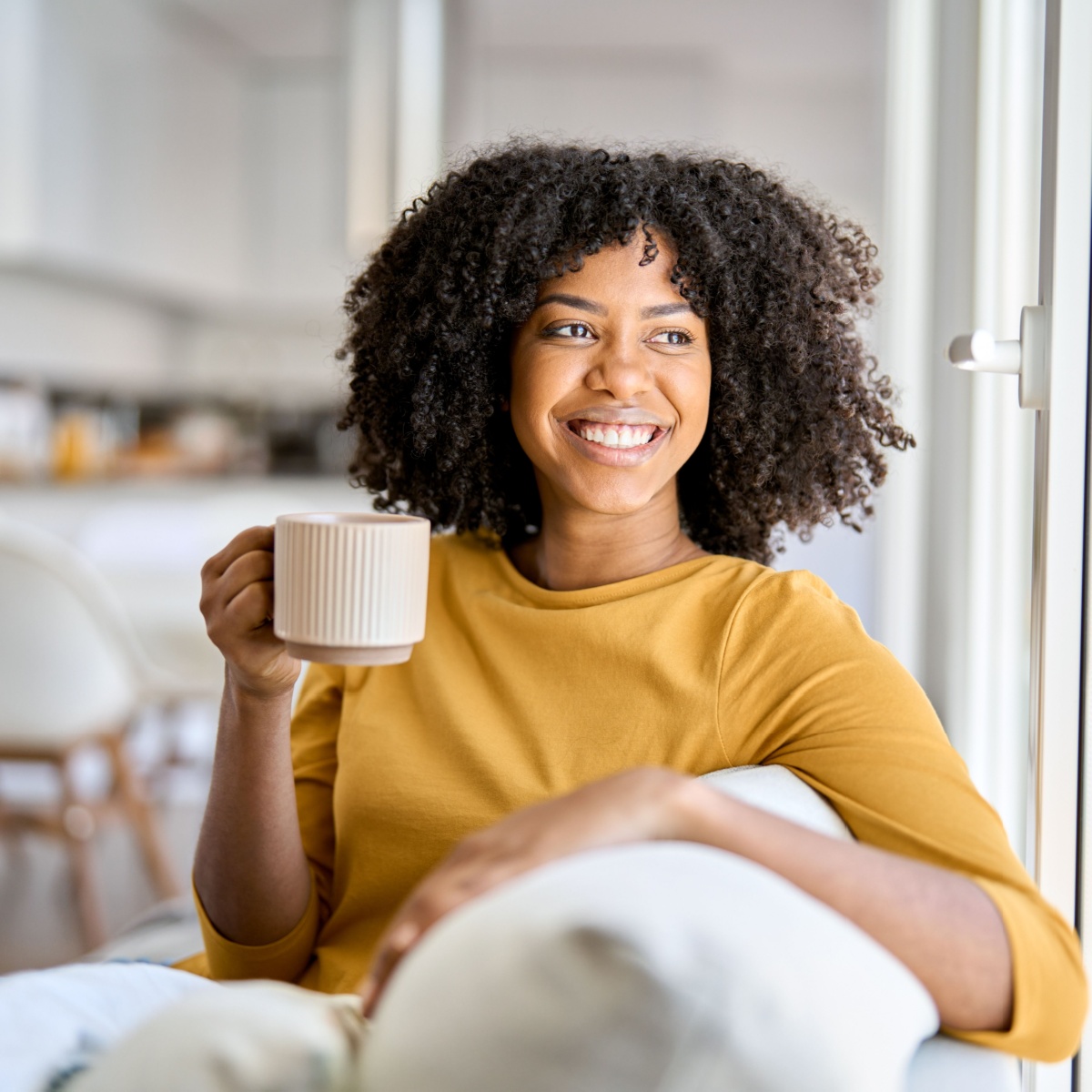 woman sitting drinking from a cup