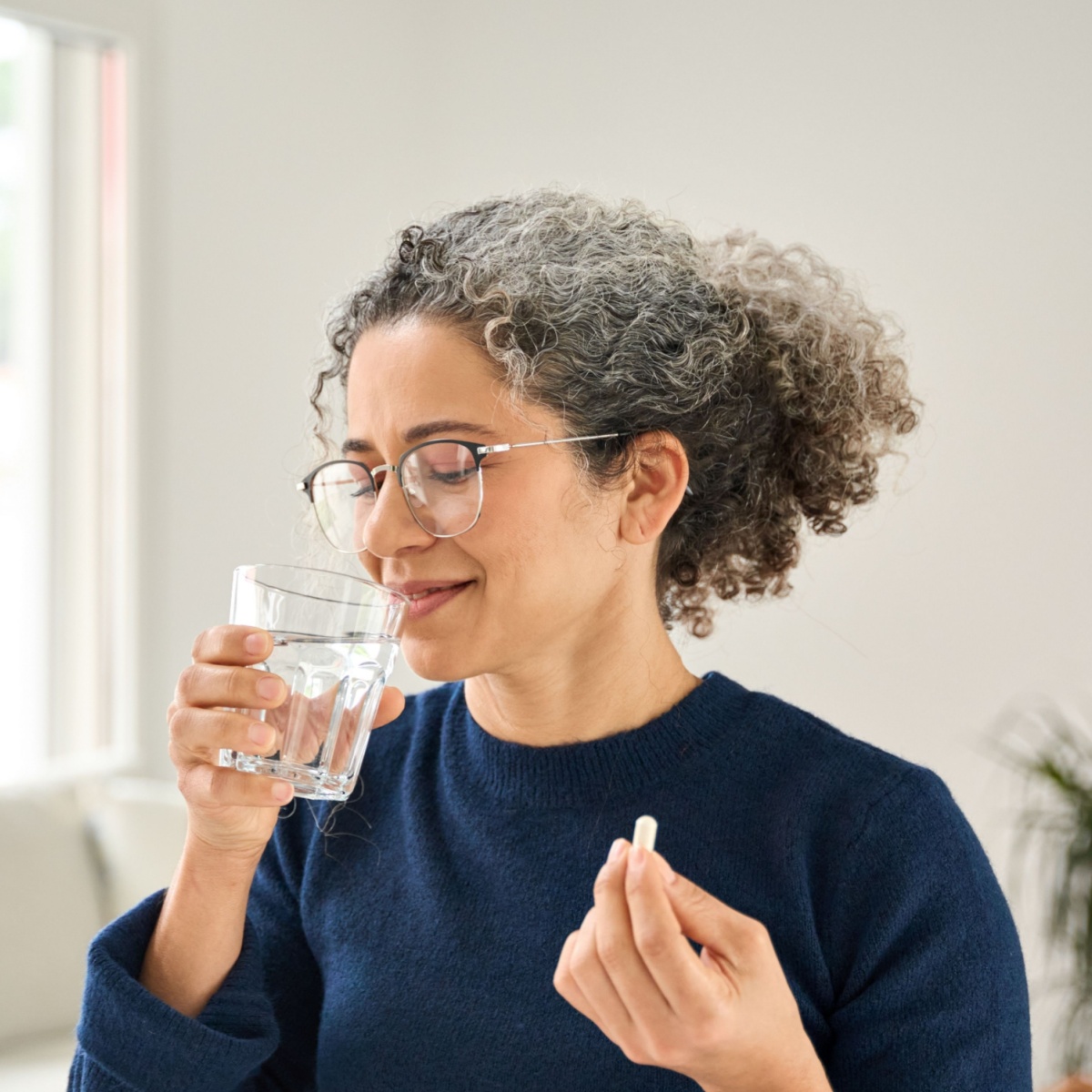 woman taking supplement