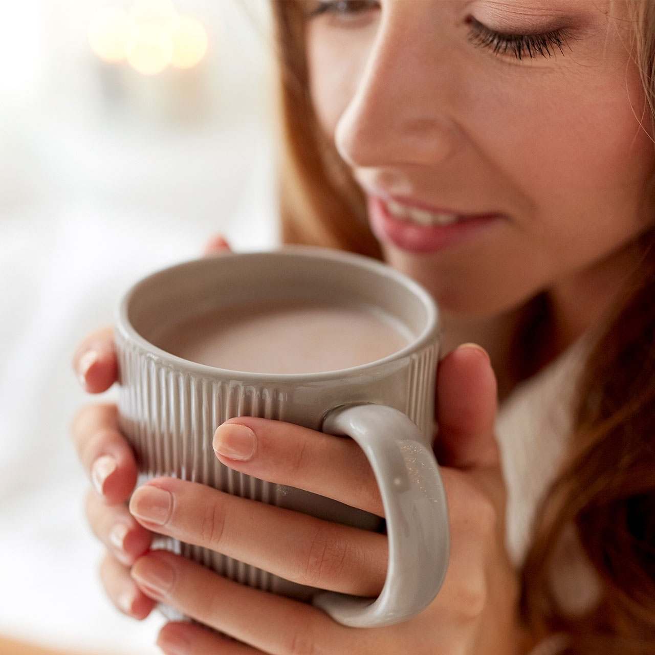 woman-sipping-mug-milk