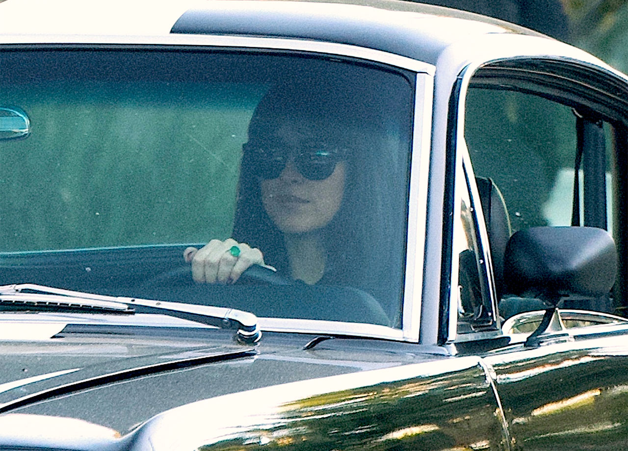 dakota johnson with emerald engagement ring driving car