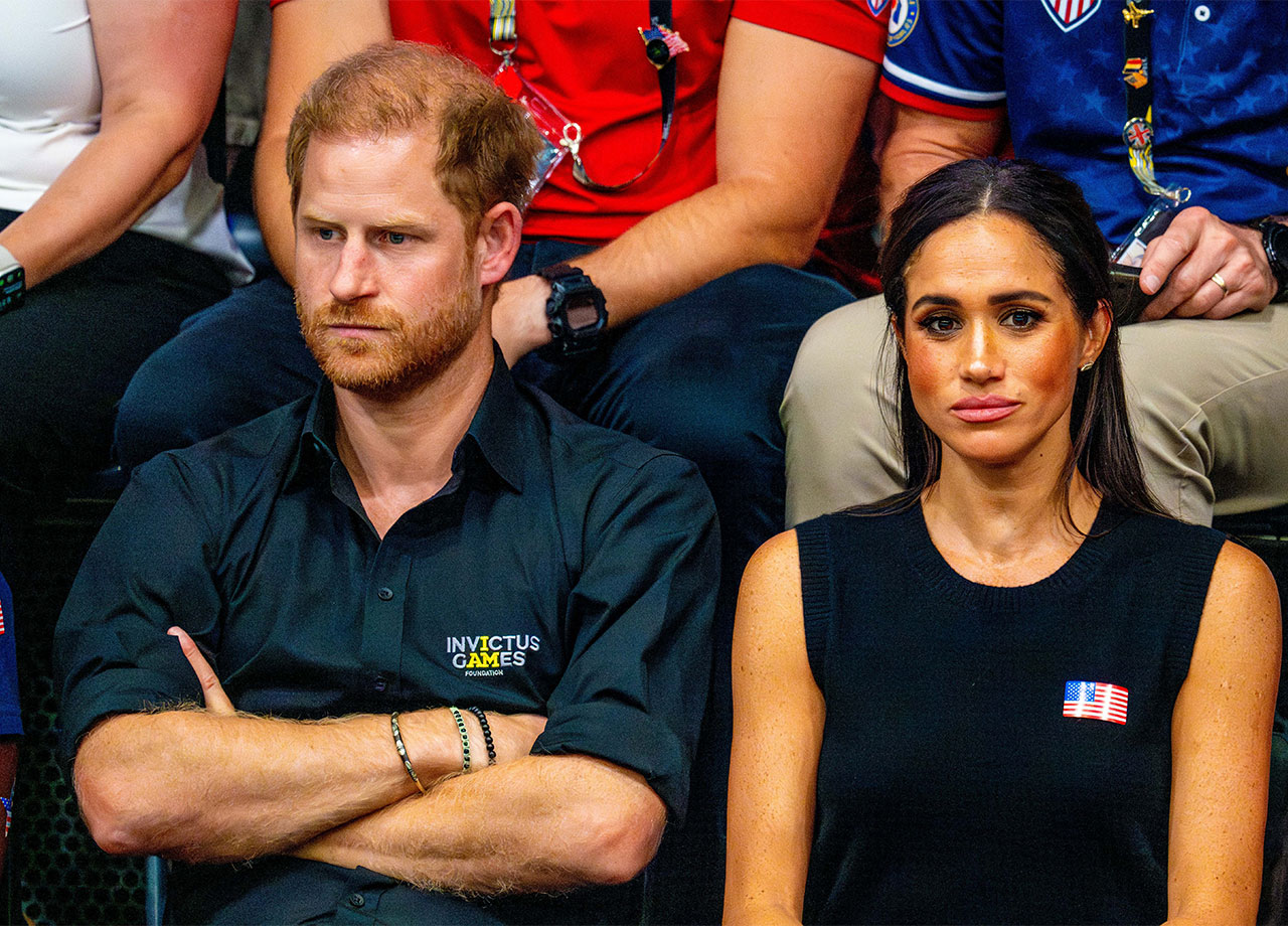 Prince Harry and Meghan Markle looking serious