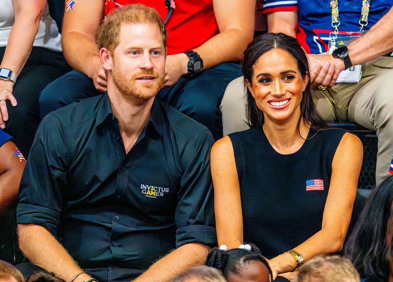 Prince Harry and Meghan Markle looking happy at Invictus Games 2023