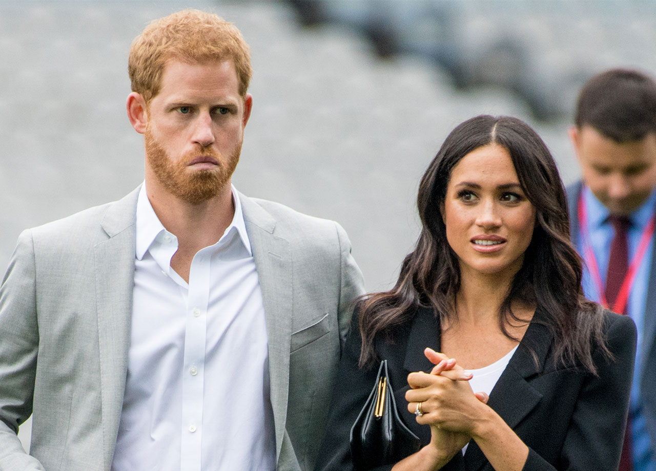 Prince Harry and Meghan Markle frowning