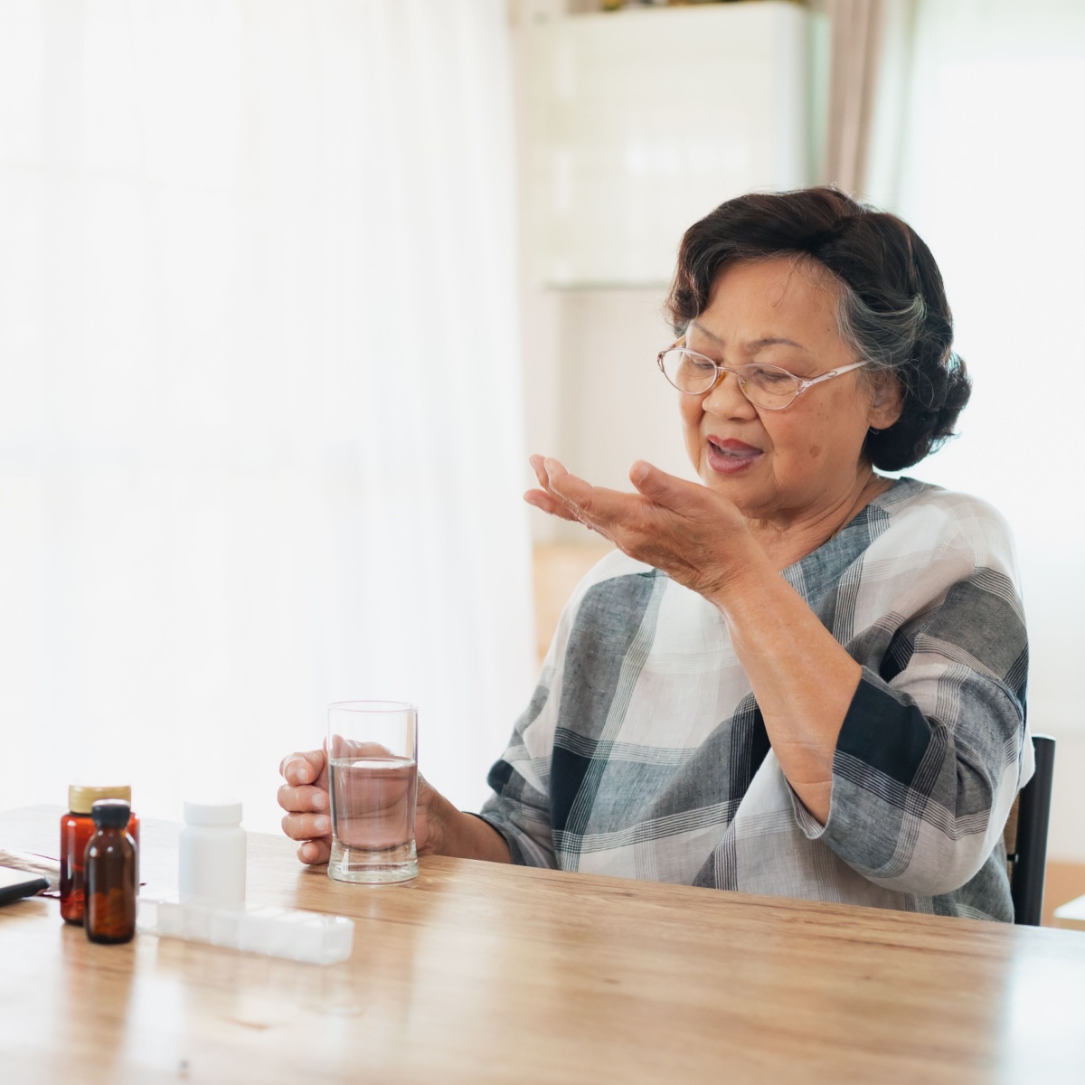 older woman taking supplement