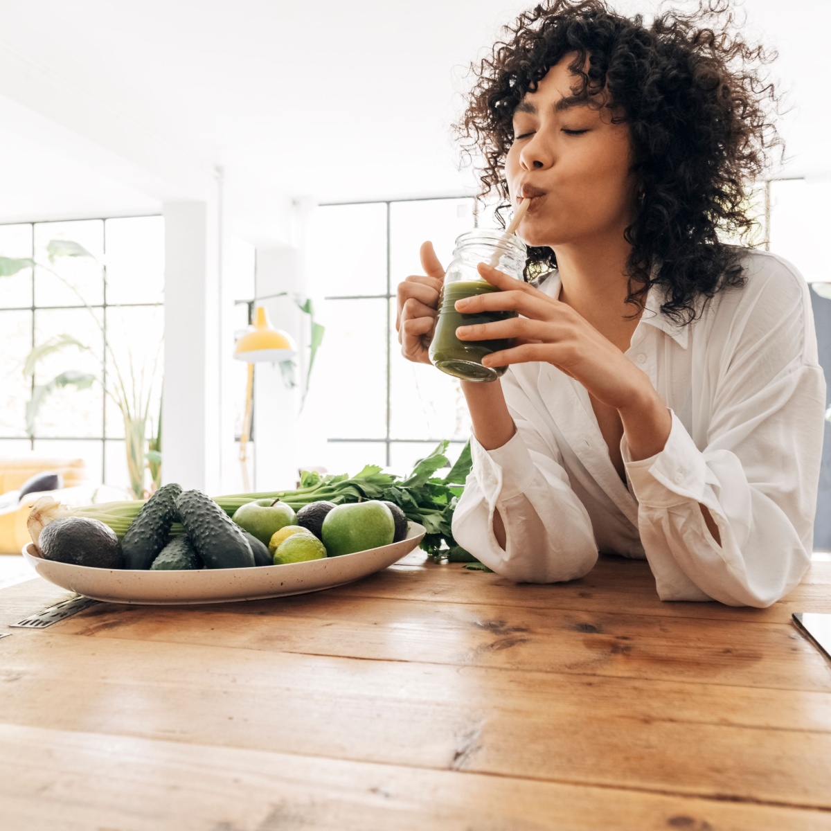 woman drinking green juice