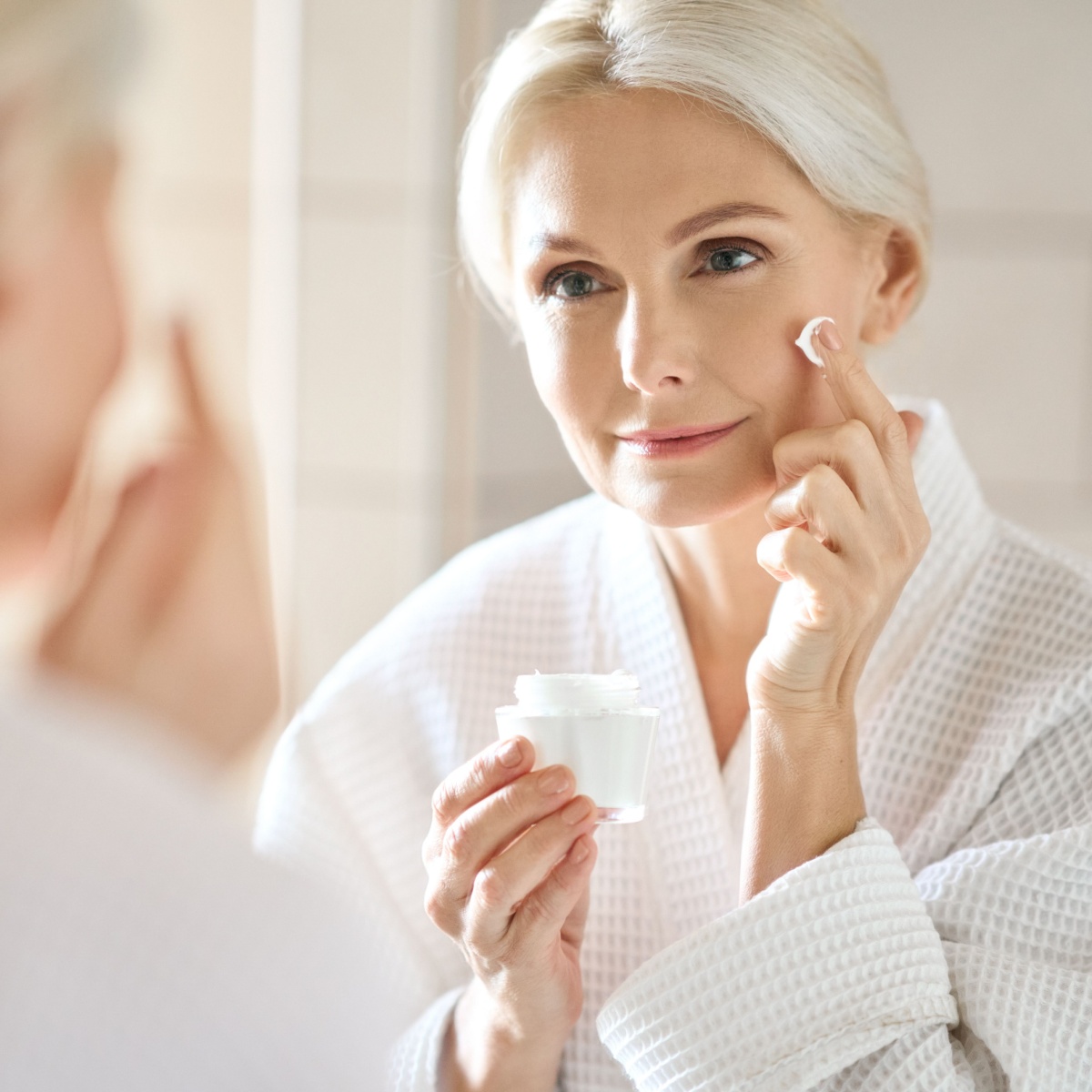 woman applying face cream