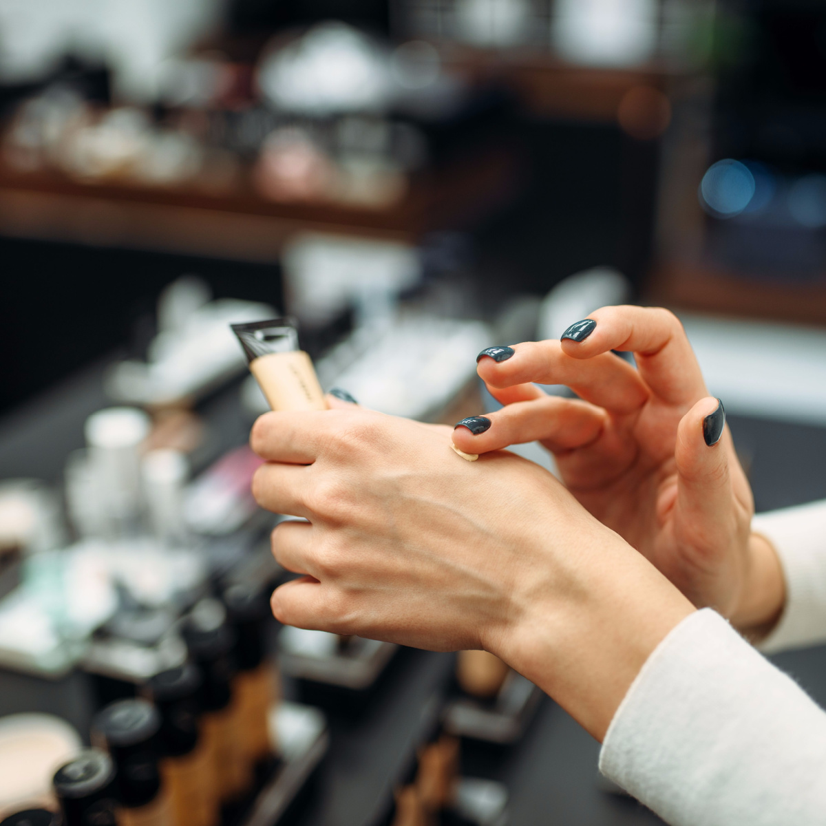 woman applying foundation on hand