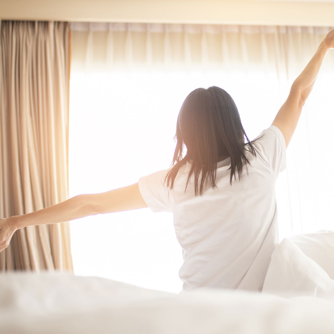 woman waking up and stretching