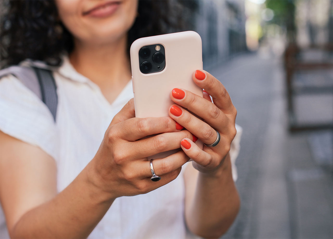 woman-red-nails-using-iphone