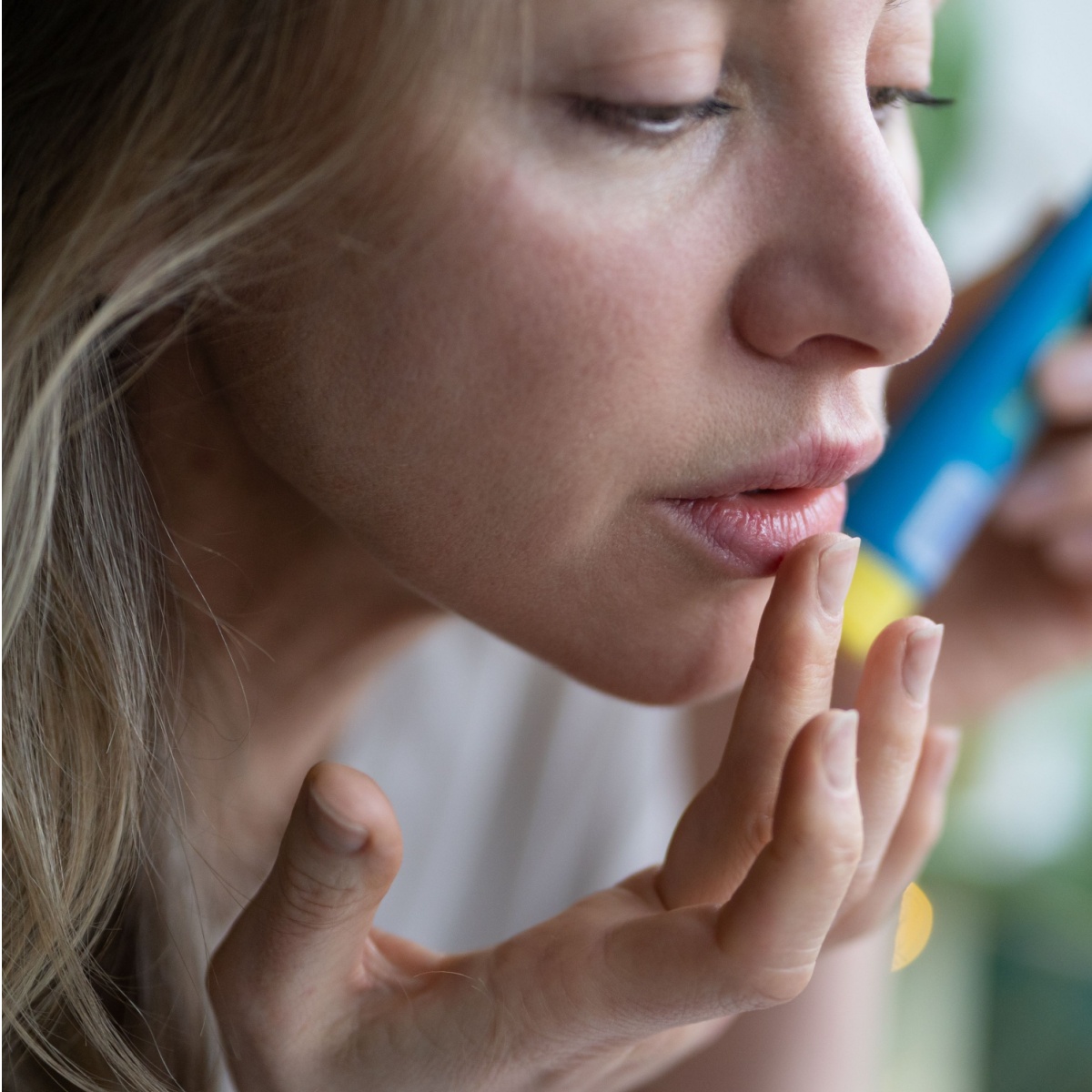 woman applying lip balm