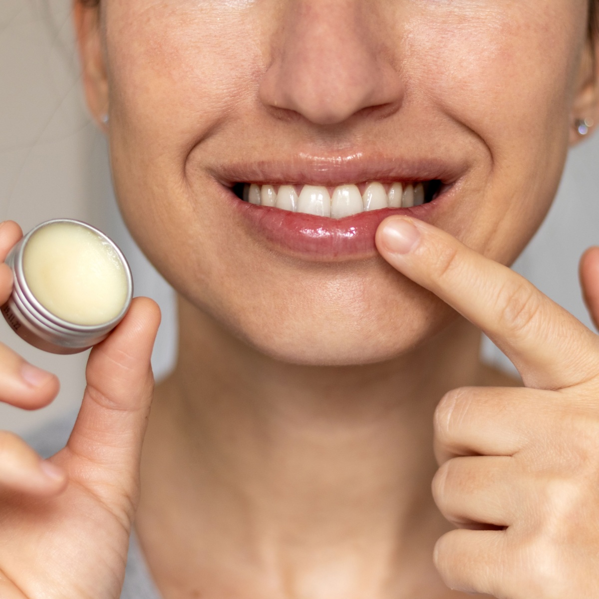 woman applying lip balm