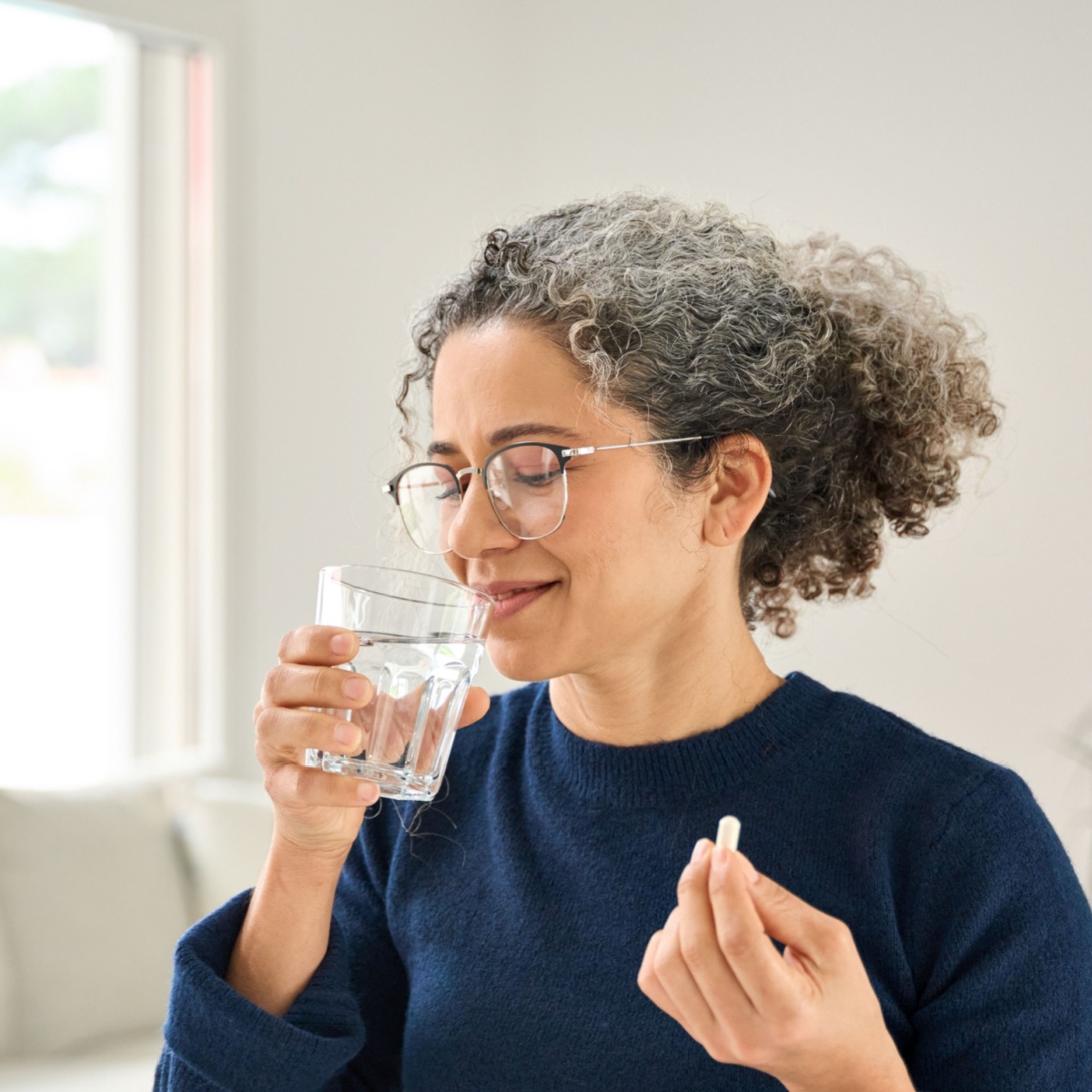 woman taking supplement