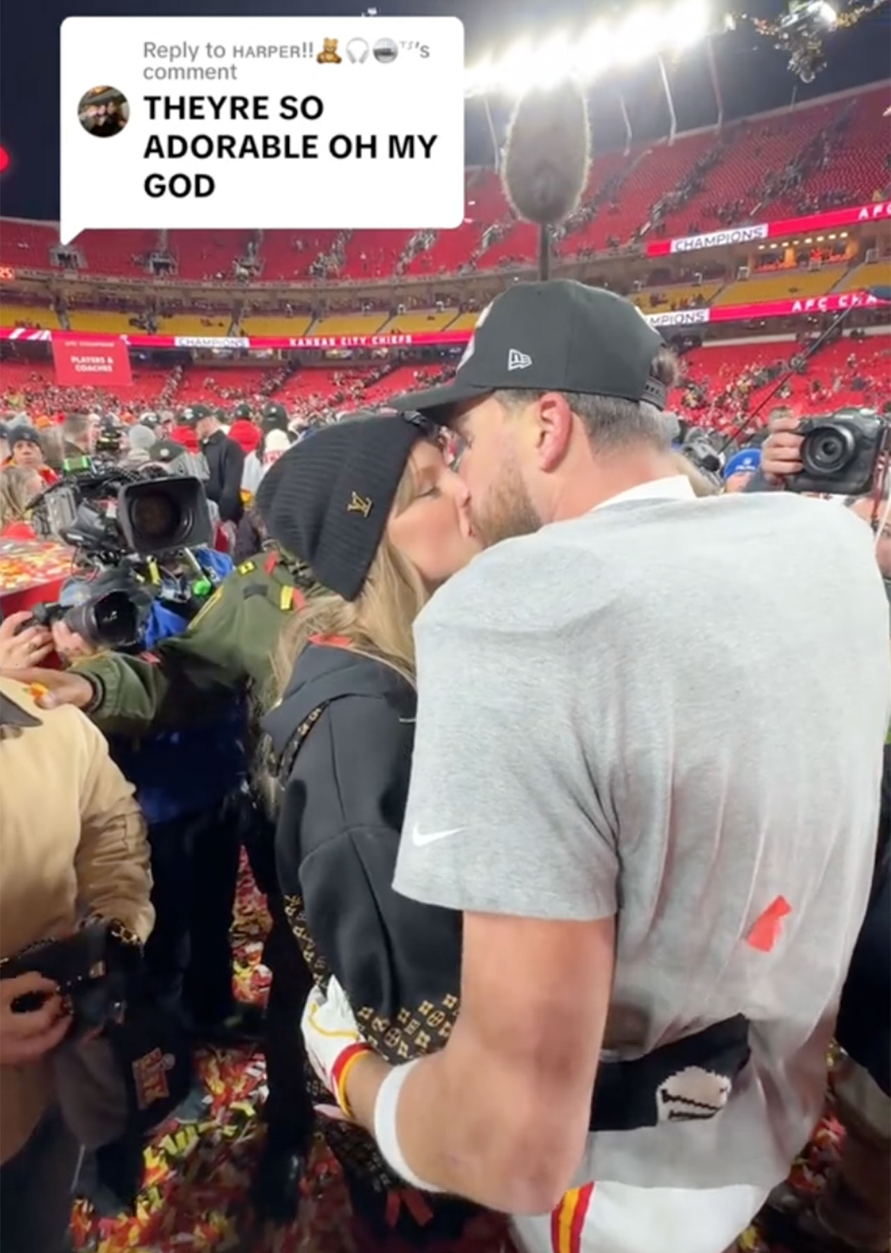 Travis Kelce and Taylor Swift kiss on football field