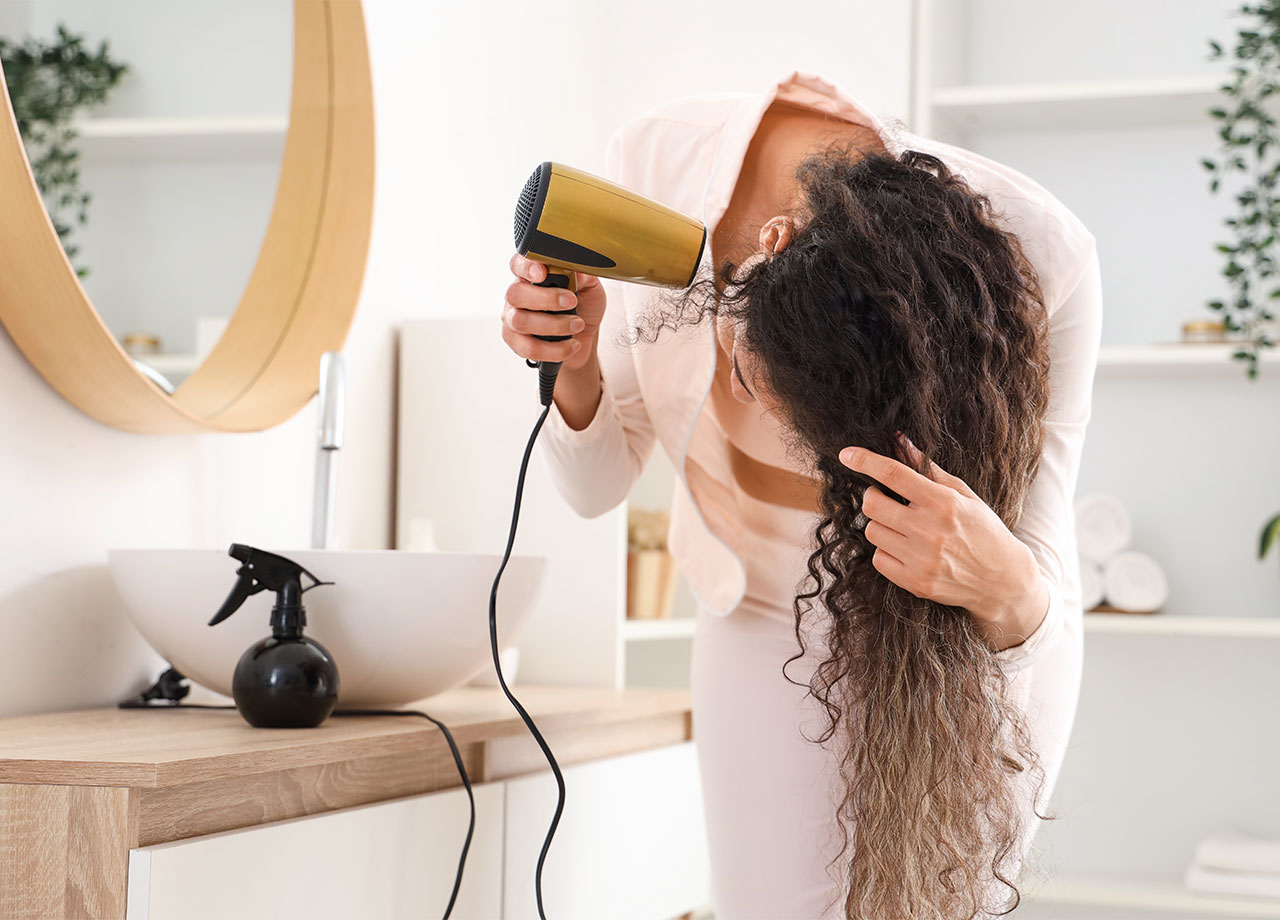 woman-blow-drying-hair-upside-down