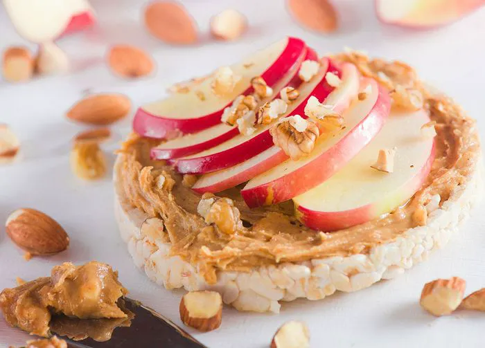 Almond butter and apple slices on a rice cake