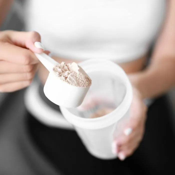 woman making protein shake
