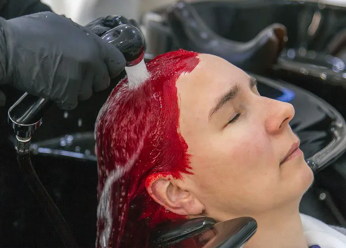 woman-rinsing-red-hair