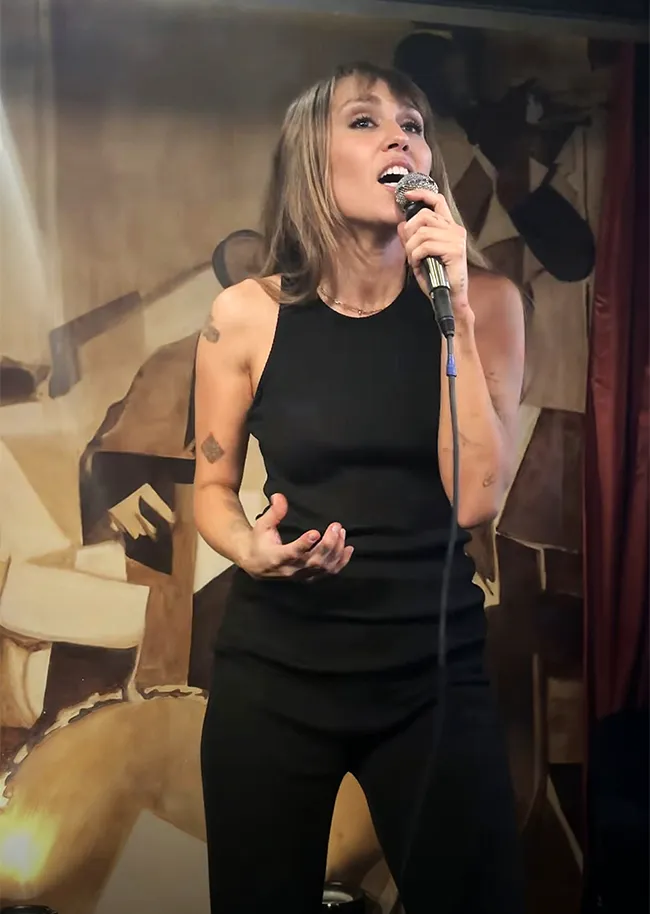 Miley Cyrus singing at a party
